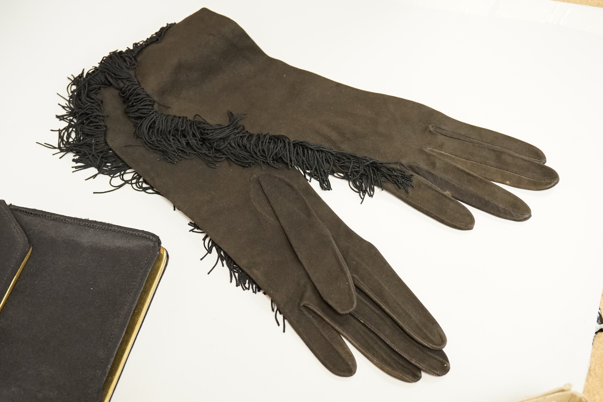 A cut steel fronter, a jet beaded panel, a pair of fringed black suede gauntlets, a seed pearl headdress, etc.